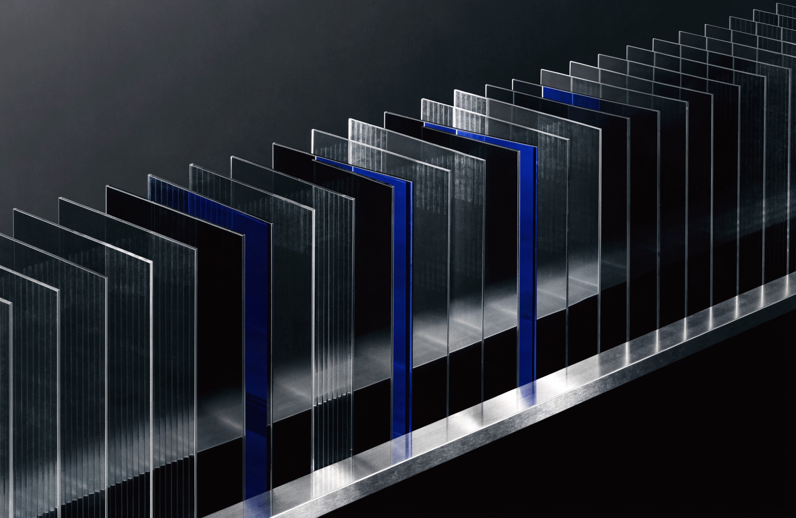 Aligned glass fins and blue channels forming an abstract information system