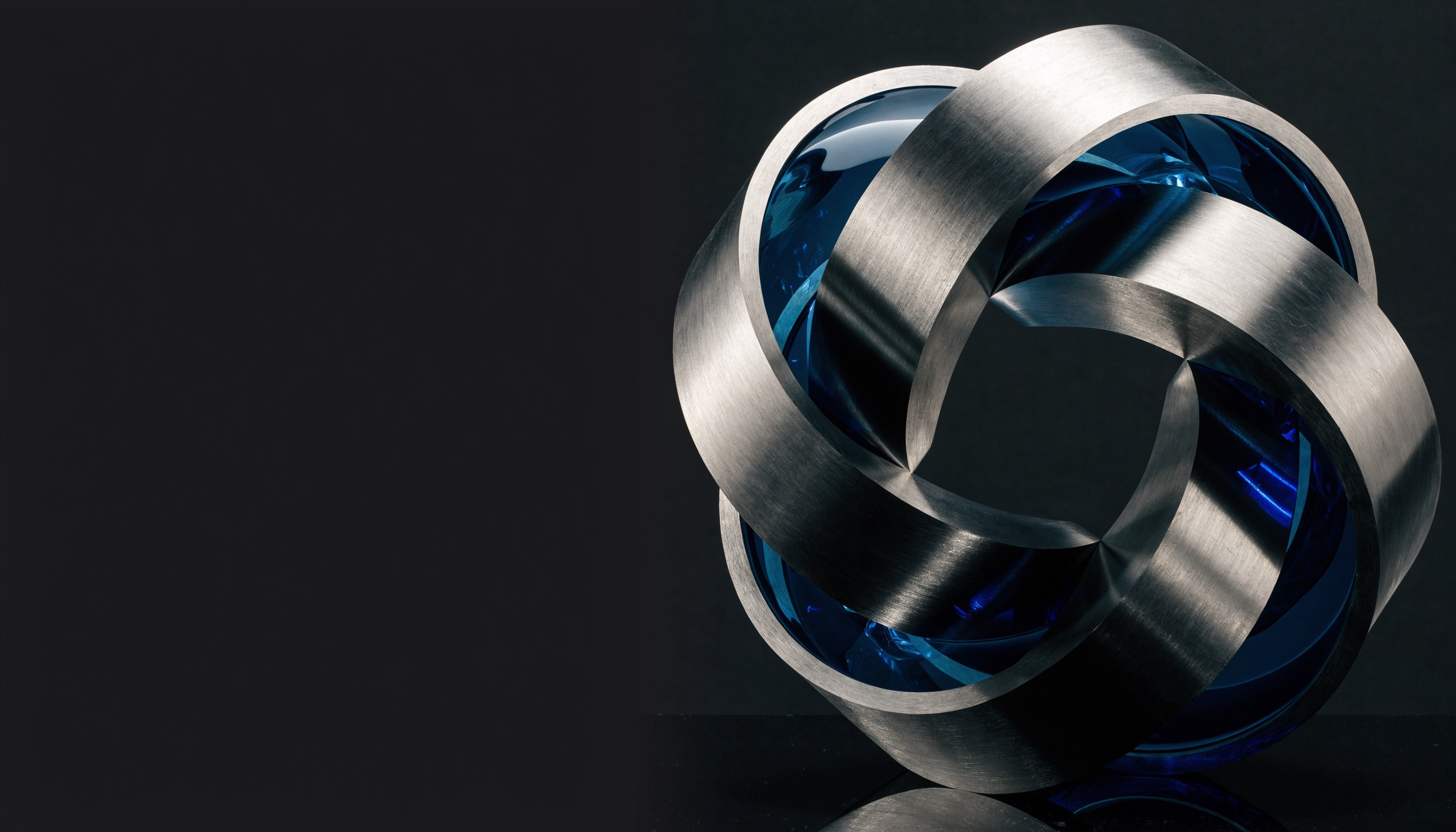 Interlocking titanium and cobalt forms representing connected, adaptable systems